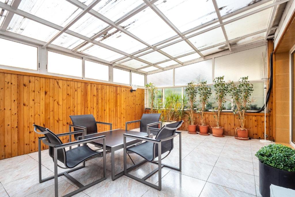 a room with a table and chairs and potted plants at Stay U-nique Apartments Marina in Barcelona