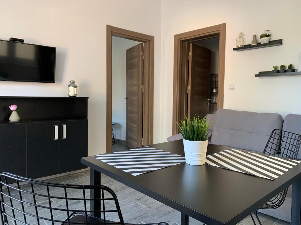 a living room with a table and a couch at Apartman Spring in Sombor