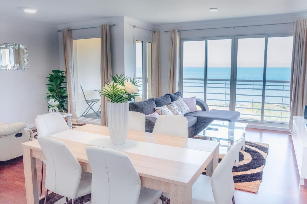 a living room with a table and a couch at Dorisol Vista Formosa by rentallido in Funchal