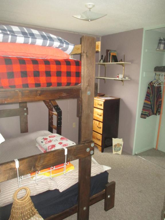 a bedroom with a bunk bed and a desk at Nice Bunk Bed in Whitehorse