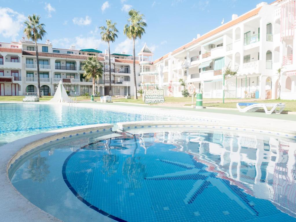 a large swimming pool in front of a building at Apartamentos Marineu Playa Romana in Alcossebre