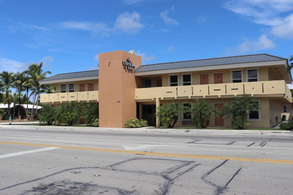 a building on the side of a street with a road at Curtis Inn & Suites in Hollywood