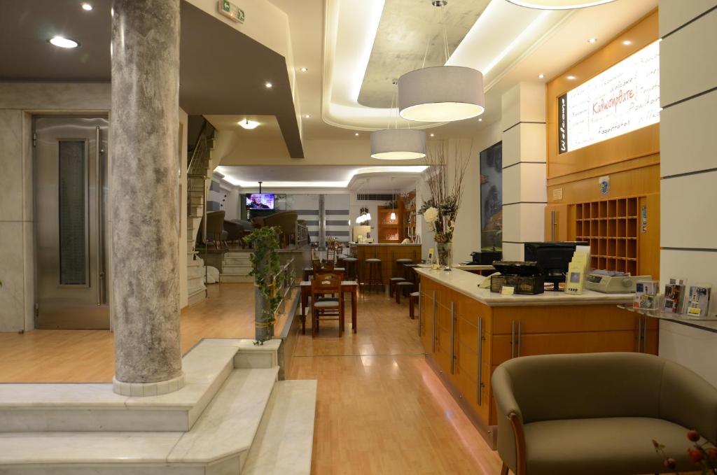 a lobby with a table and chairs in a building at Marie Palace in Patra