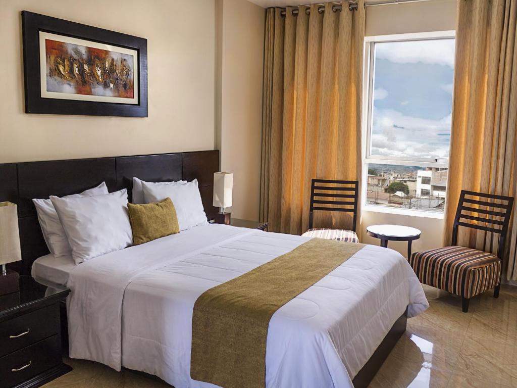 a hotel room with a large bed and a window at Riosol Tarapoto Hotel in Tarapoto