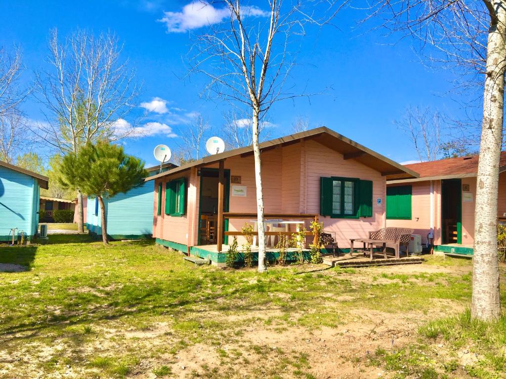 a house with a yard and trees in front of it at Chalets Tuscany Viareggio in Viareggio