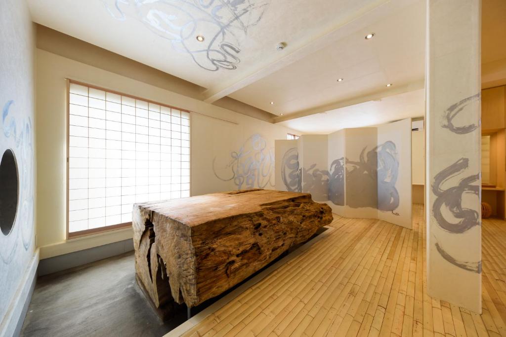 um quarto com uma grande cama de madeira num quarto com uma janela em Yuigahama 千世 em Kamakura