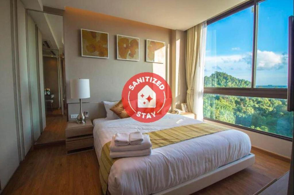 a hotel room with a bed with a sign on it at Phu Dahla Residences in Ao Nang Beach