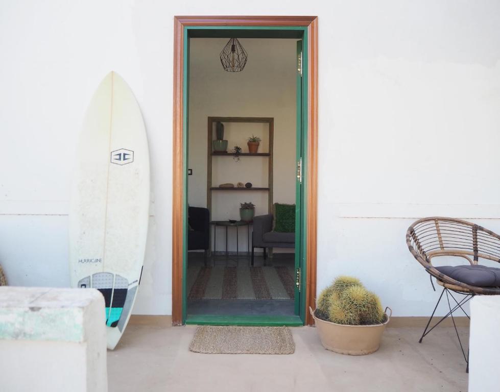 a door leading into a room with a surfboard at Studio Aqua in La Oliva