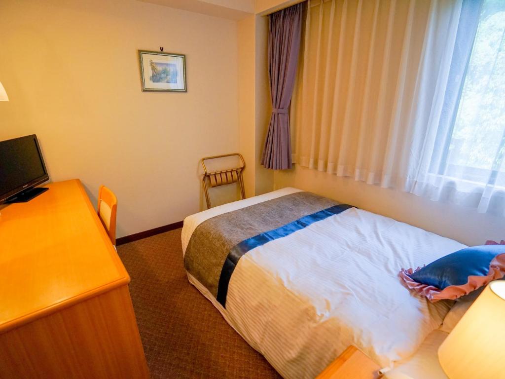 Postel nebo postele na pokoji v ubytování Hotel Areaone Wadayama