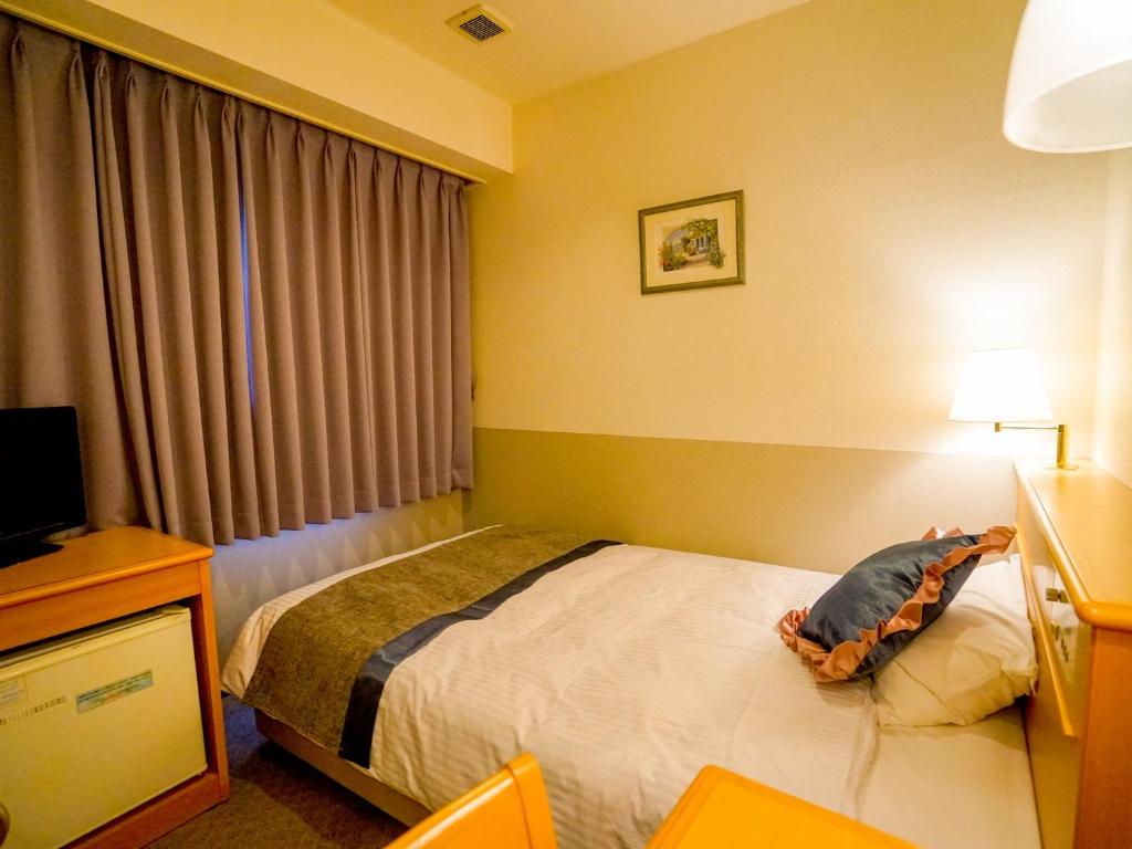 Postel nebo postele na pokoji v ubytování Hotel Areaone Wadayama
