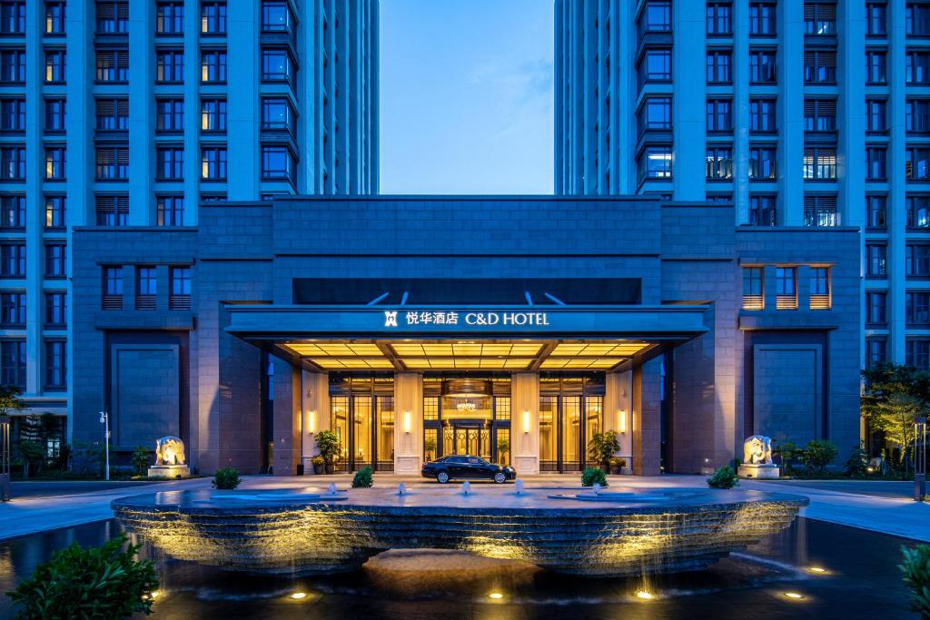 a building with a car in front of it at C&D Hotel,Xiamen Xiang'an-Late Check Out & Free Welcome Snacks in Xiamen