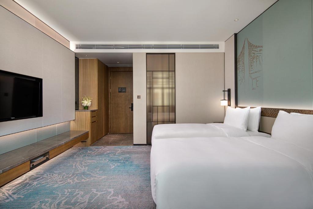 Postel nebo postele na pokoji v ubytování C&D Hotel,Xiamen Xiang'an-Late Check Out & Free Welcome Snacks