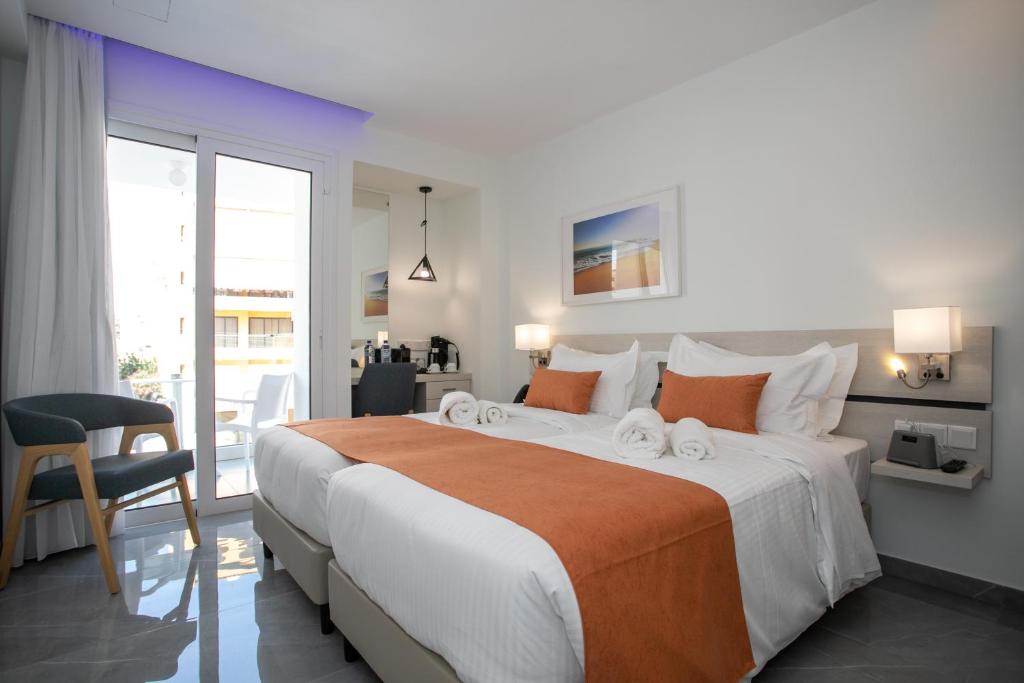 a bedroom with a large bed and a balcony at Best Western Plus Larco Hotel in Larnaka