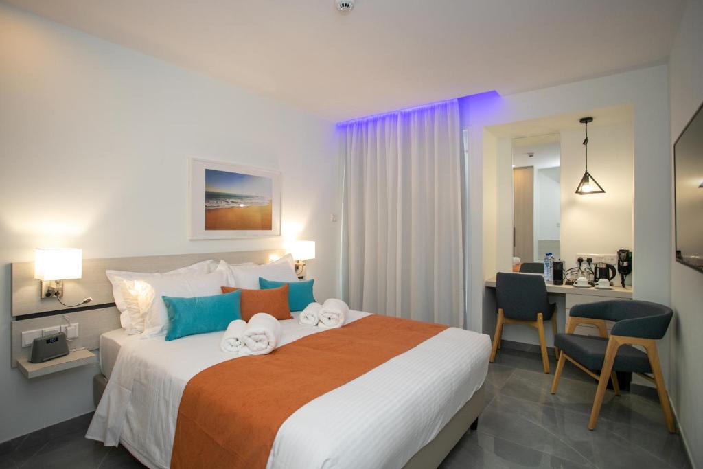 a hotel room with a bed and a desk at Best Western Plus Larco Hotel in Larnaka