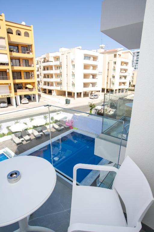 a balcony with a view of a pool and buildings at Best Western Plus Larco Hotel in Larnaka
