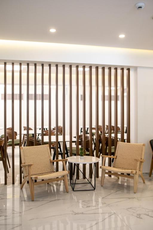 a dining room with two chairs and a table at Best Western Plus Larco Hotel in Larnaka