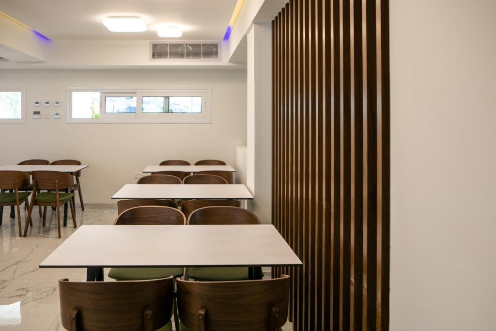 a row of tables and chairs in a room at Best Western Plus Larco Hotel in Larnaka