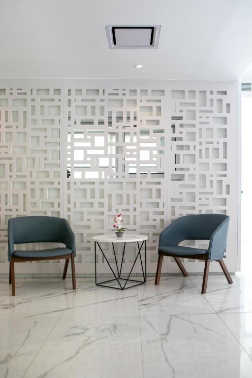 two chairs and a table in a room at Best Western Plus Larco Hotel in Larnaka