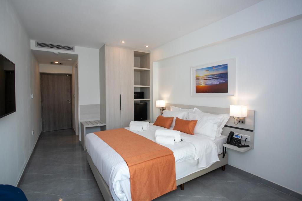 a bedroom with a large bed and a television at Best Western Plus Larco Hotel in Larnaka