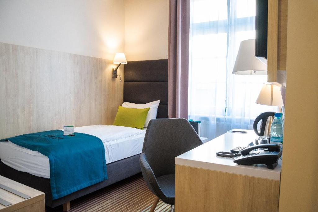 Postel nebo postele na pokoji v ubytování Stay inn Hotel Gdańsk