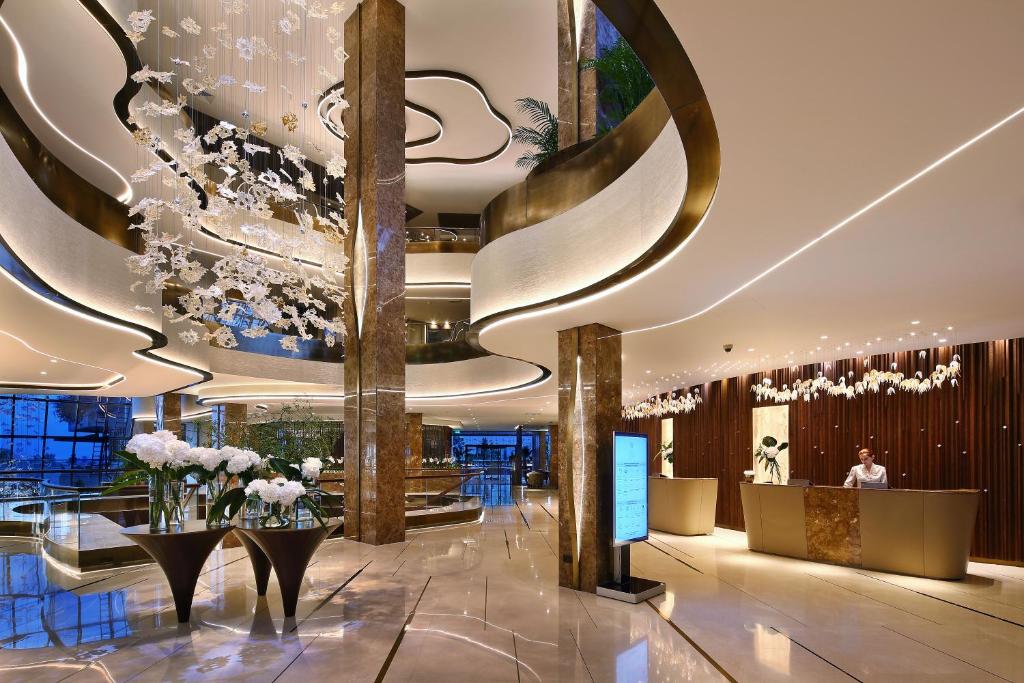 a lobby of a hotel with a large ceiling at Four Seasons Hotel in Limassol
