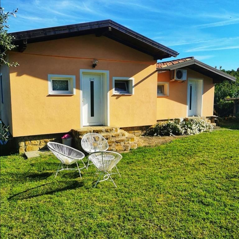 a house with two chairs and a house at Apartments Jagodje in Izola