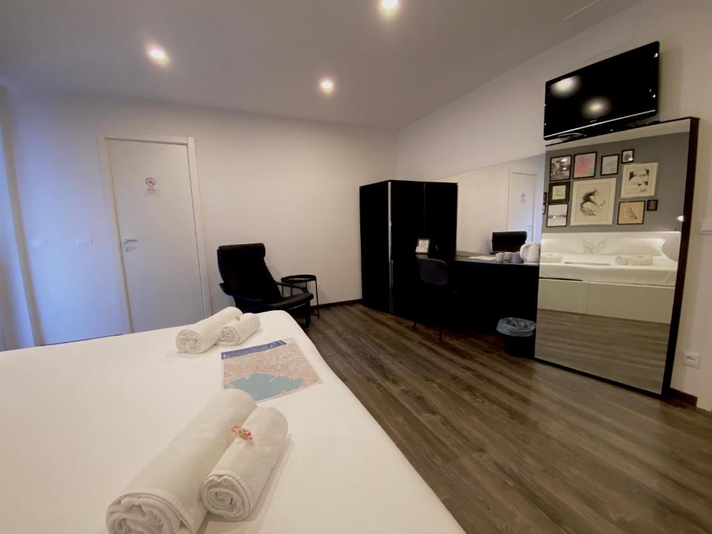 Posteľ alebo postele v izbe v ubytovaní Mimì Rooms&Studios