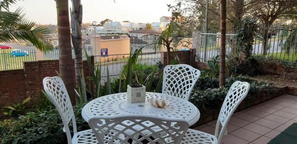 a white table and chairs on a patio at 57 on Plover in George