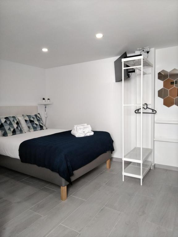 a bedroom with a bed and a book shelf at Tomarhousing - Studio in Tomar