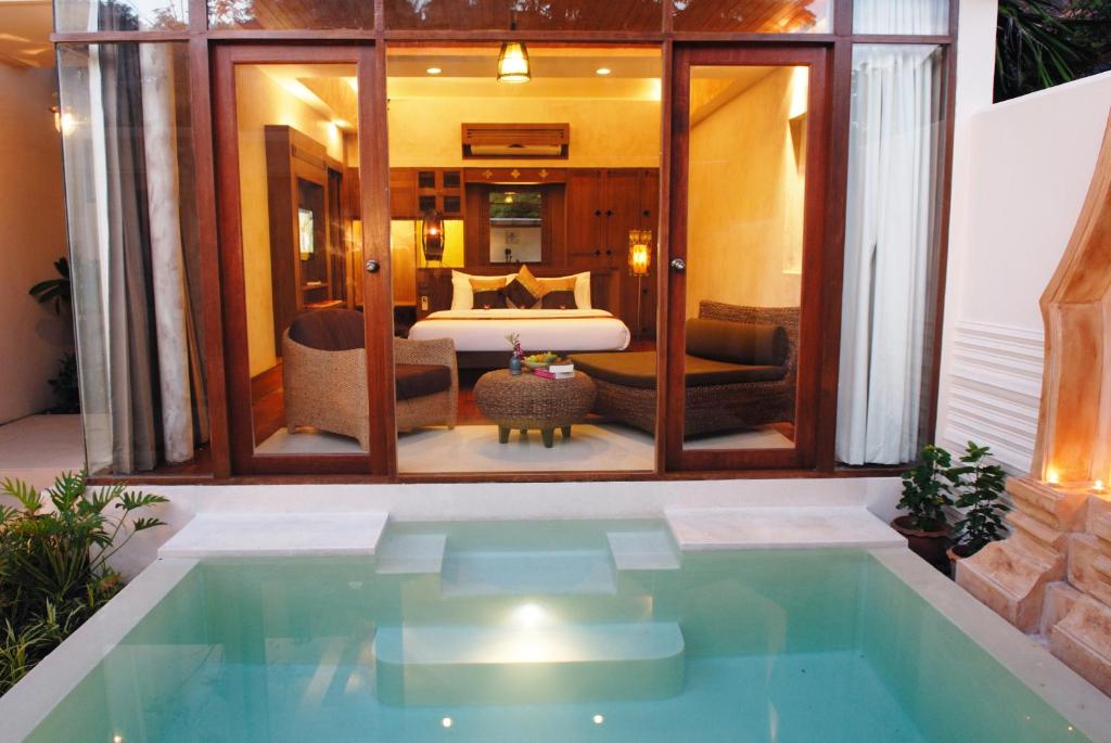 a pool in a room with a bed and a bedroom at Montien House - SHA Plus in Chaweng