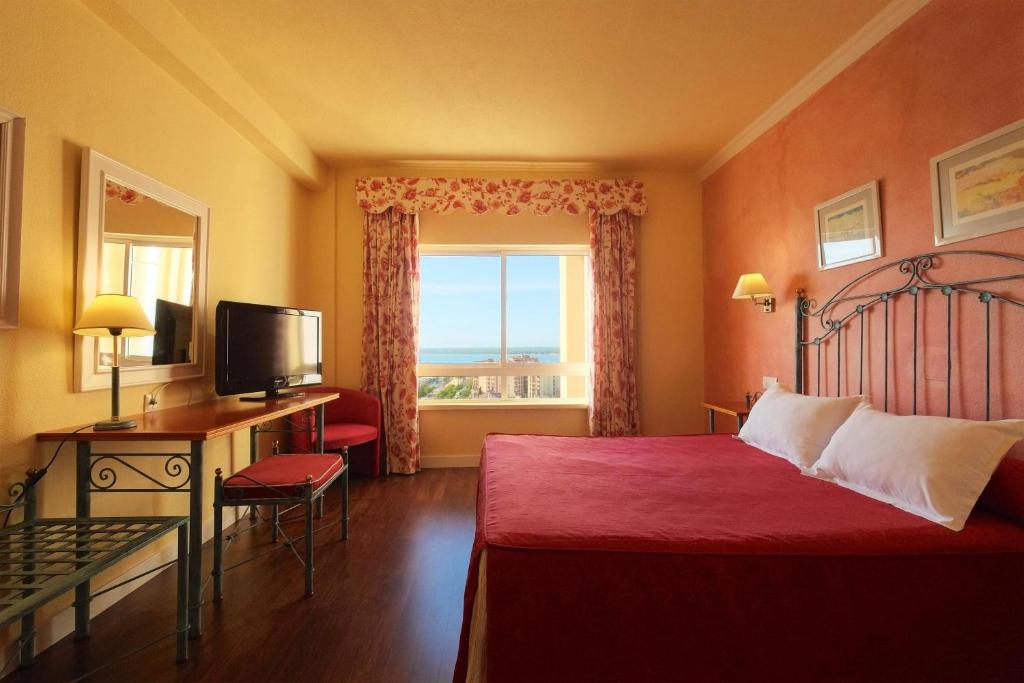 Postel nebo postele na pokoji v ubytování Hotel Guadalquivir