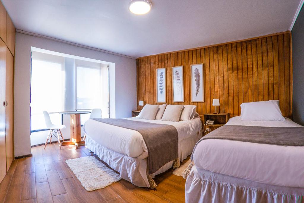 Postel nebo postele na pokoji v ubytování Etnico Bío Bío Hotel