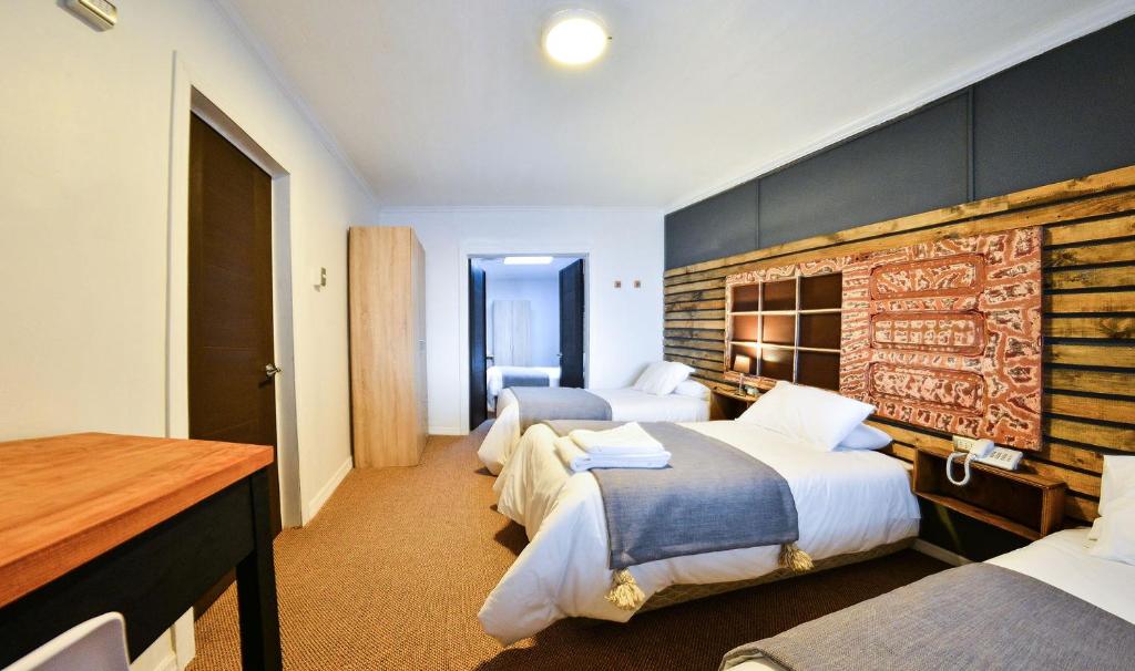 Postel nebo postele na pokoji v ubytování Etnico Bío Bío Hotel
