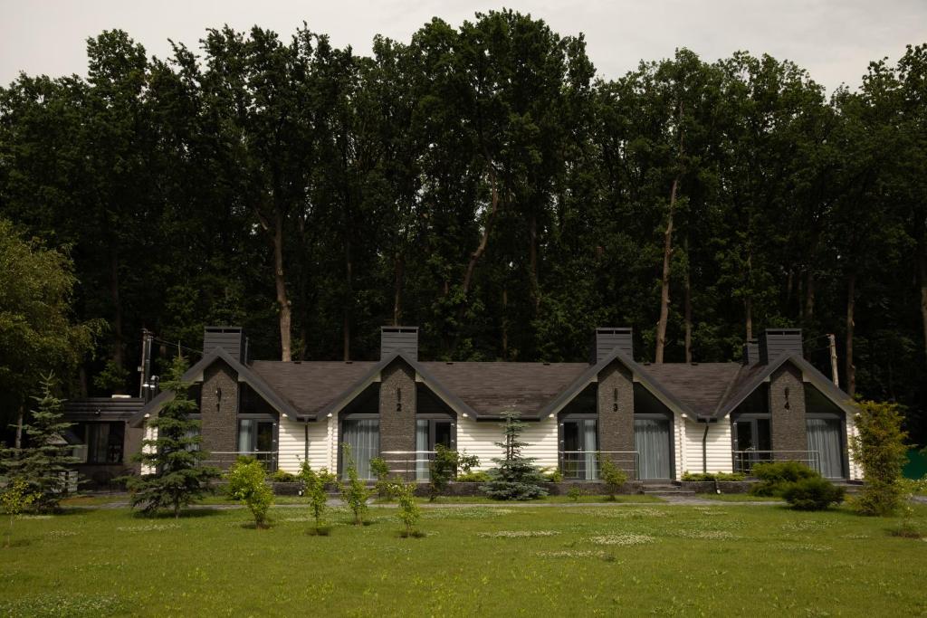 a house with a green lawn in front of it at Телячі Ніжності in Umanʼ