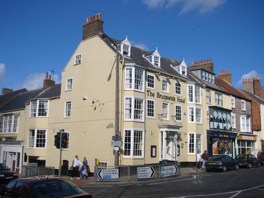 a large yellow building on the corner of a street at The Brunswick Hotel in Bridlington