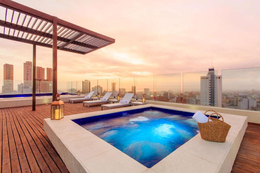 a swimming pool on the roof of a building at NH Collection Royal Smartsuites in Barranquilla