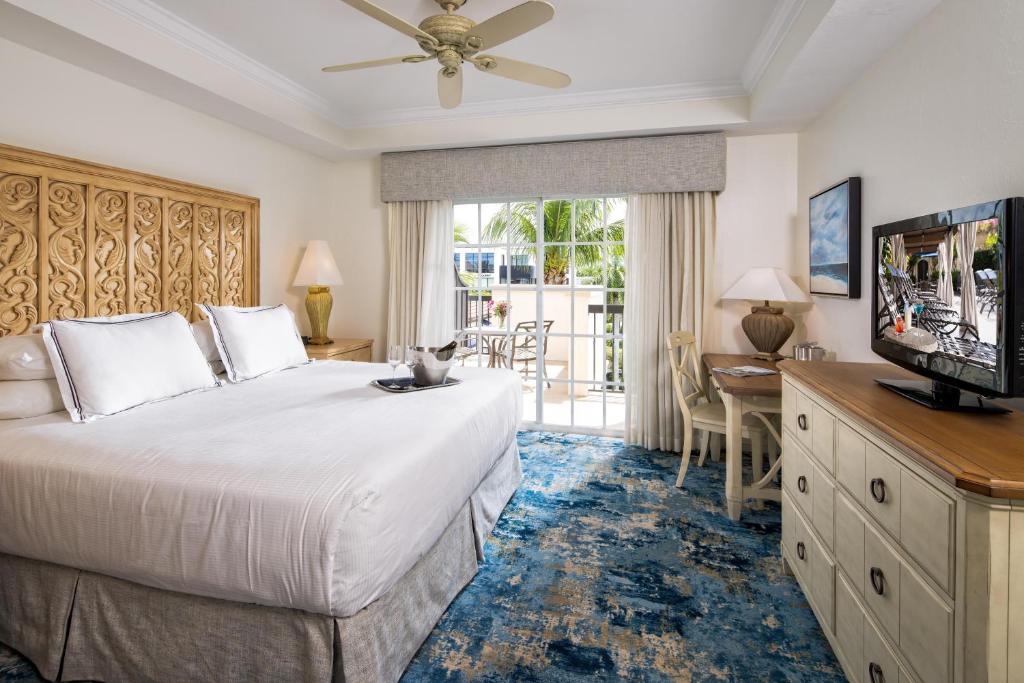 a hotel room with a bed and a television at Bellasera Resort in Naples