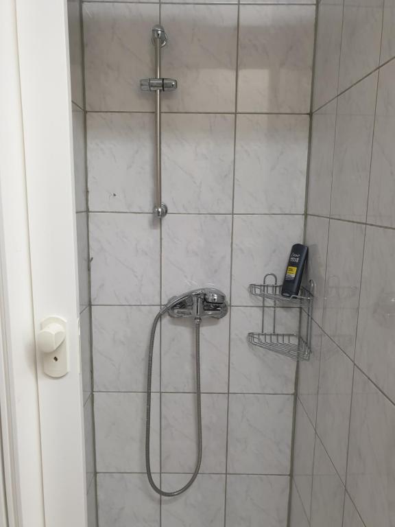 a bathroom with a shower with a phone in it at Mir hostel in Berlin