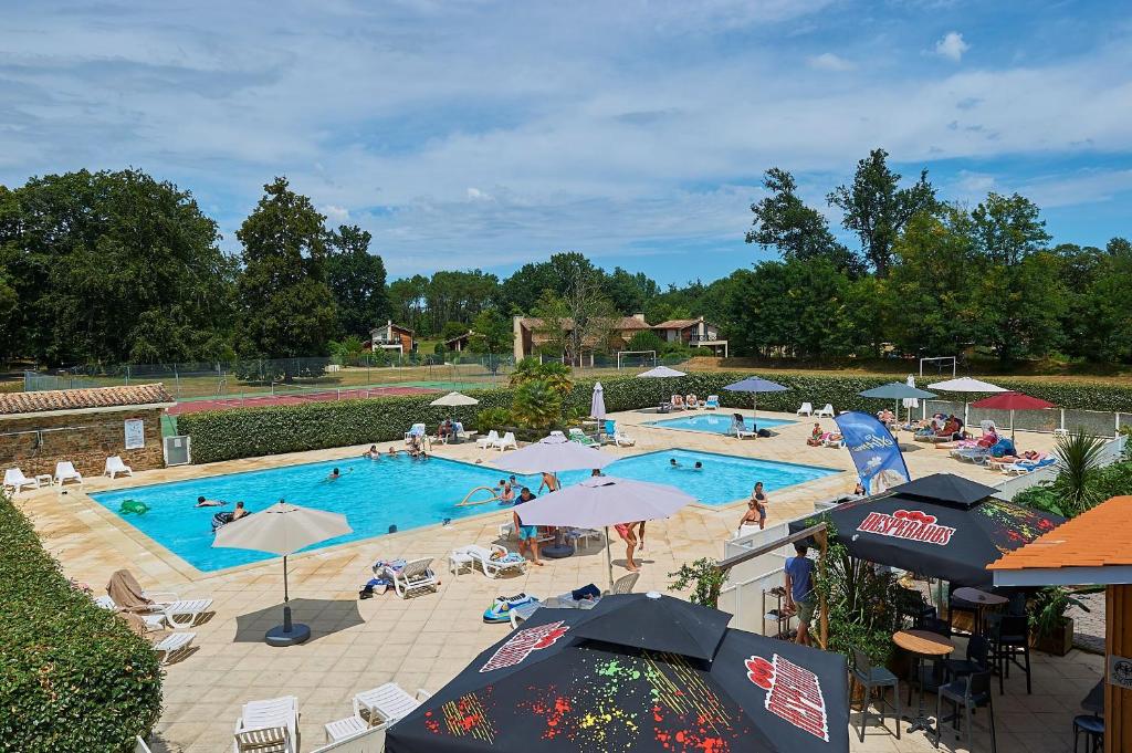 una gran piscina con gente en un complejo en Résidence Château de Salles, en Salles