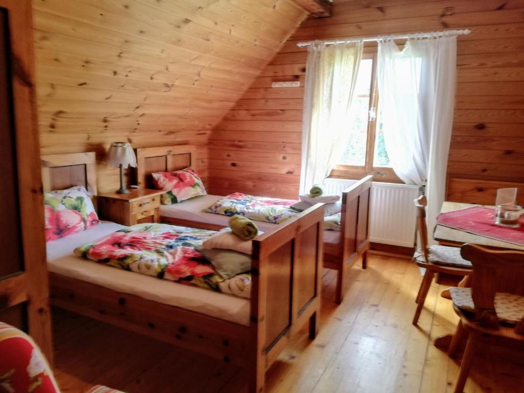 a bedroom with two beds in a log cabin at Da Tizzi in Trahütten