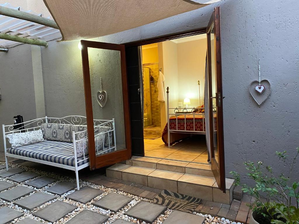 an open door to a room with a bed at Favour in Pretoria