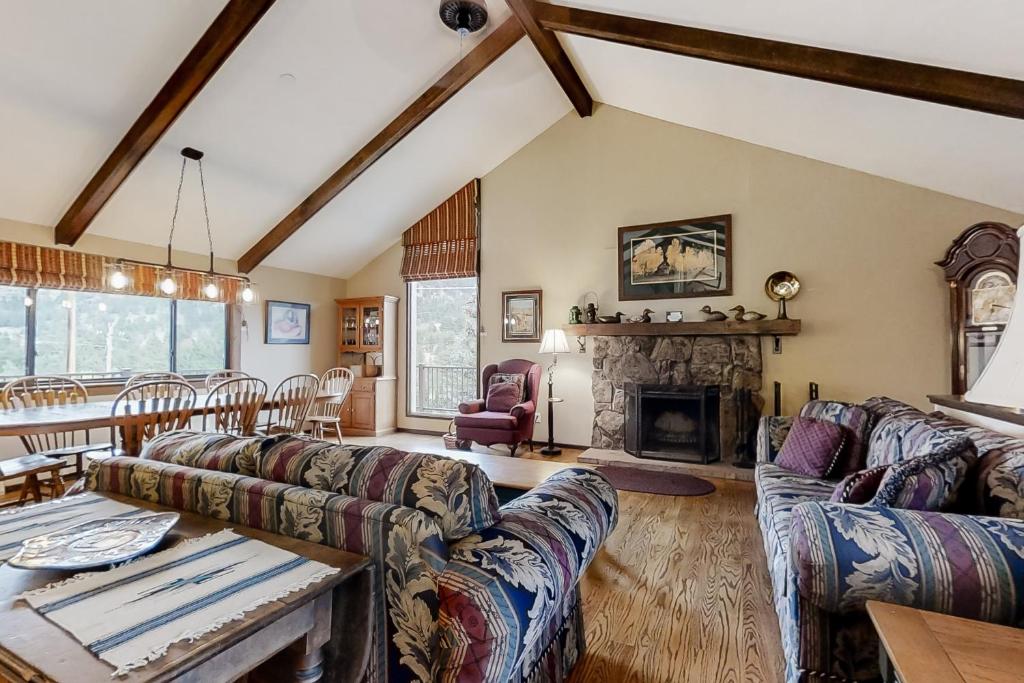 a living room with couches and a fireplace at The Blue Raven in Estes Park