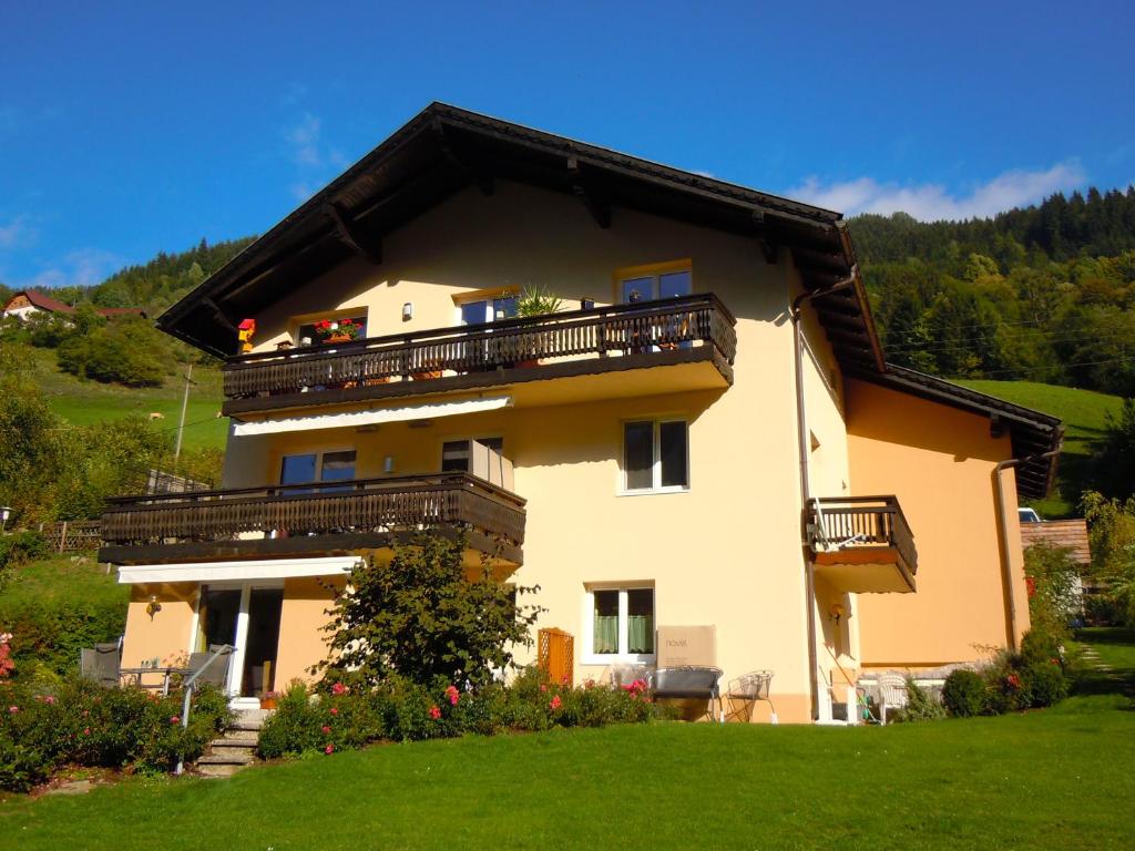a large house with a balcony on top of it at Seegarten Appartements in Feld am See