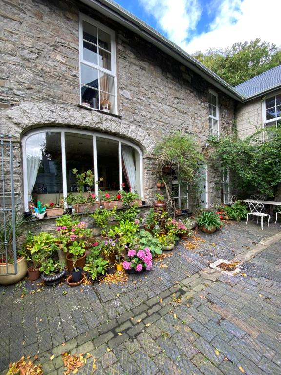 a house with a bunch of flowers in front of it at The Stables, Ulverston in Ulverston