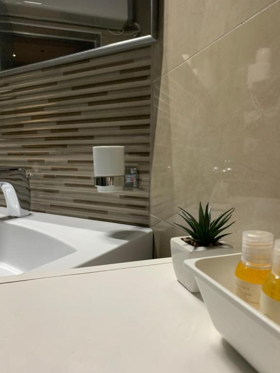 a bathroom with a sink and a bath tub at Hotel Oresti Center in Tirana