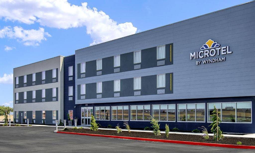 a large building with a sign on the side of it at Microtel Inn & Suites by Wyndham George in George