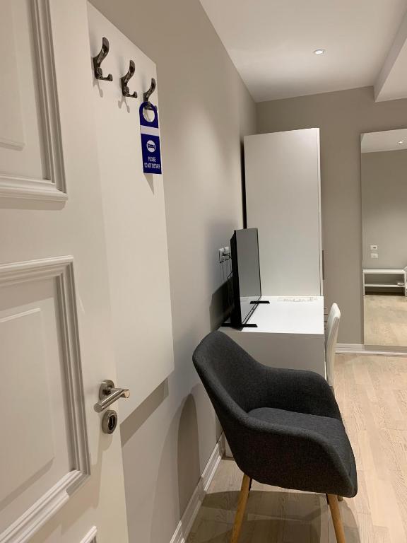 a black chair sitting at a desk in a room at Hotel Oresti Center in Tirana