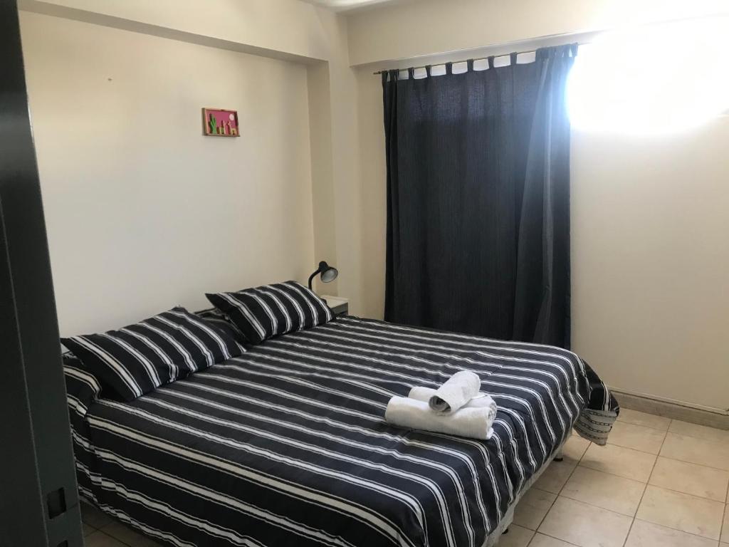 מיטה או מיטות בחדר ב-Belgrano 9