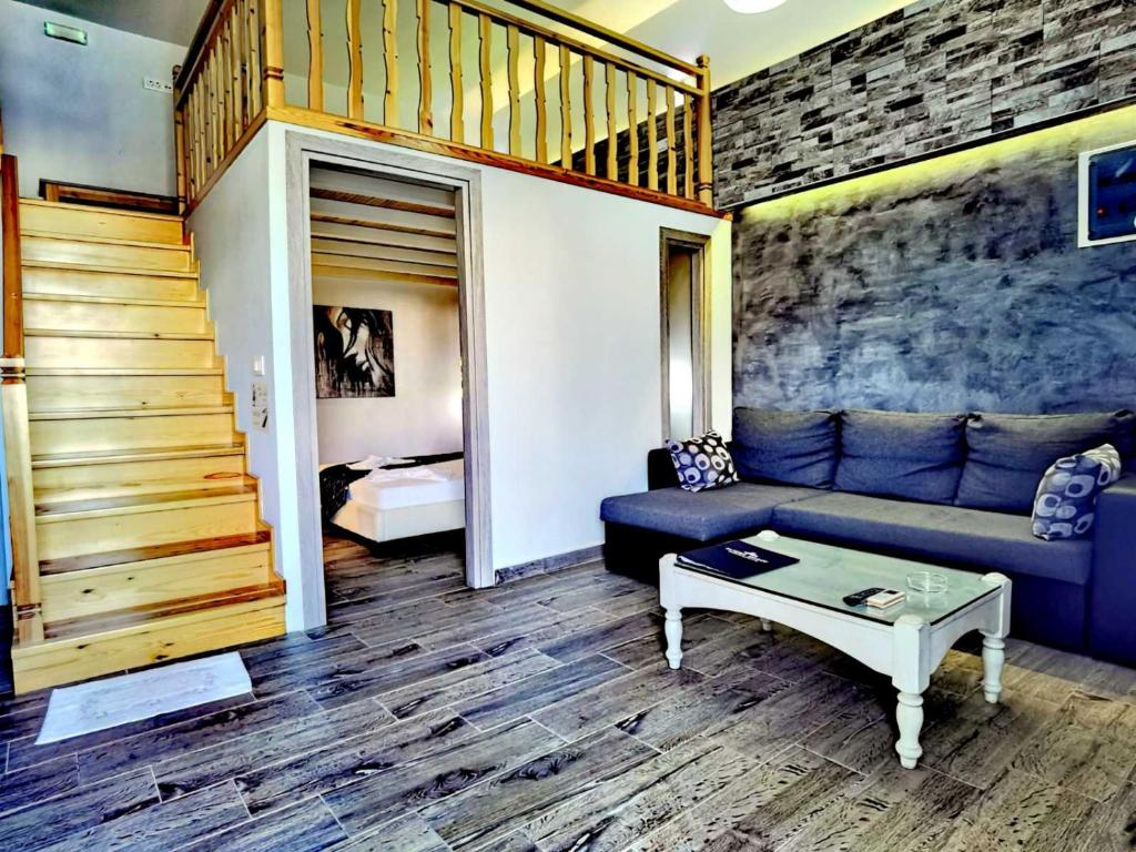 a living room with a couch and a table at Vlycha Beach Apartments in Lindos