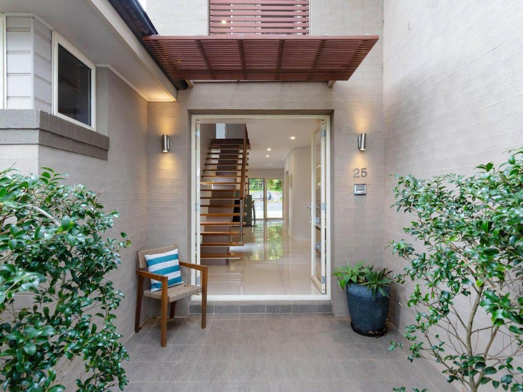 a house entrance with awning and stairs to a house at 25 Christmas Bush Avenue aircon pet friendly small boat parking and WI FI in Nelson Bay